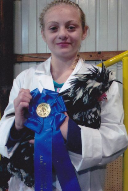 My daughter Kennedy showed poultry for the first time at our fair and placed 1st in her Continental Class with her Houdan Rooster.