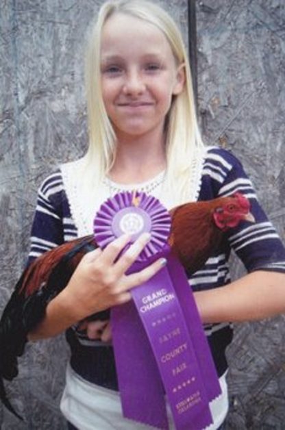 Jennifer holding a Cackle Hatchery® Cubalaya Bantam male which won the Grand champion at the Payne County Fair in Stillwater, OK 2012.