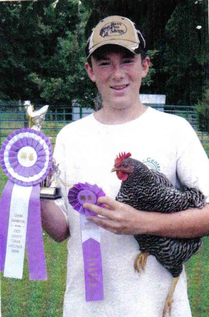 Sawyer holding Barred Plymouth Rock Chicken hen, Best in Breed and Grand Champion of Cass County Jr. Livestock Association Show 2009. Thank you Cackle Hatchery®