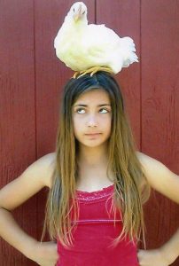 Girl with Chicken on her head. 