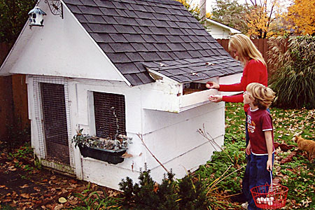 mother and child looking for eggs in hen house