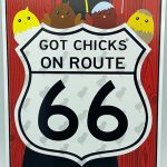 A sign that reads "Get Chicks on Route 66"