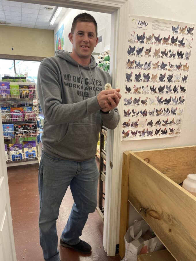 Man holding baby chick