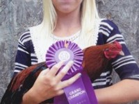 Jennifer holding a Cackle Hatchery® Cubalaya Bantam male which won the Grand champion at the Payne County Fair in Stillwater, OK 2012.