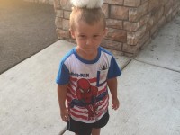 Little boy with chick on head..
