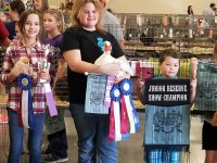 Winners holding their animals and ribbons