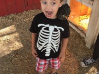 Little boy with chicken on shoulder