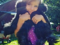 Girl holding two black polish chickens