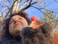 Chicken and Woman looking into the distance