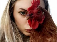 Lady posing with brown leghorn chicken