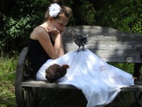 Girl on bench with two chickens