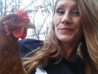 Lady posing with red chicken