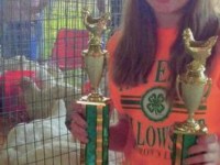 Girl holding 2 Trophys
