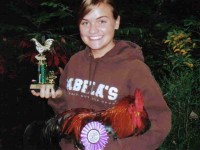 Girl Holding Chicken and Award