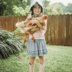 girl holding chicken