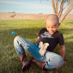 Boy playing with baby chick