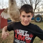 Boy with chicken on shoulder