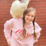 girl with chicken on her shoulder