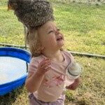 girl with chicken on her head