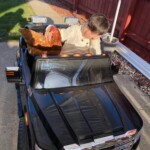Boy with chicken in his toy car