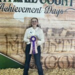 Cassandra Burns - Girl holding ribbon winning chicken