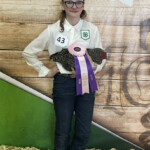 Cassandra Burns - Girl holding ribbon winning chicken