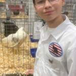 boy with his chicken in cage