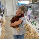 Girl holding her chicken