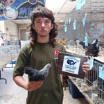 man holding award with chicken in the other hand
