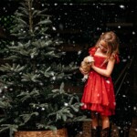 Melanie Sajnog - holding chicken near christmas tree